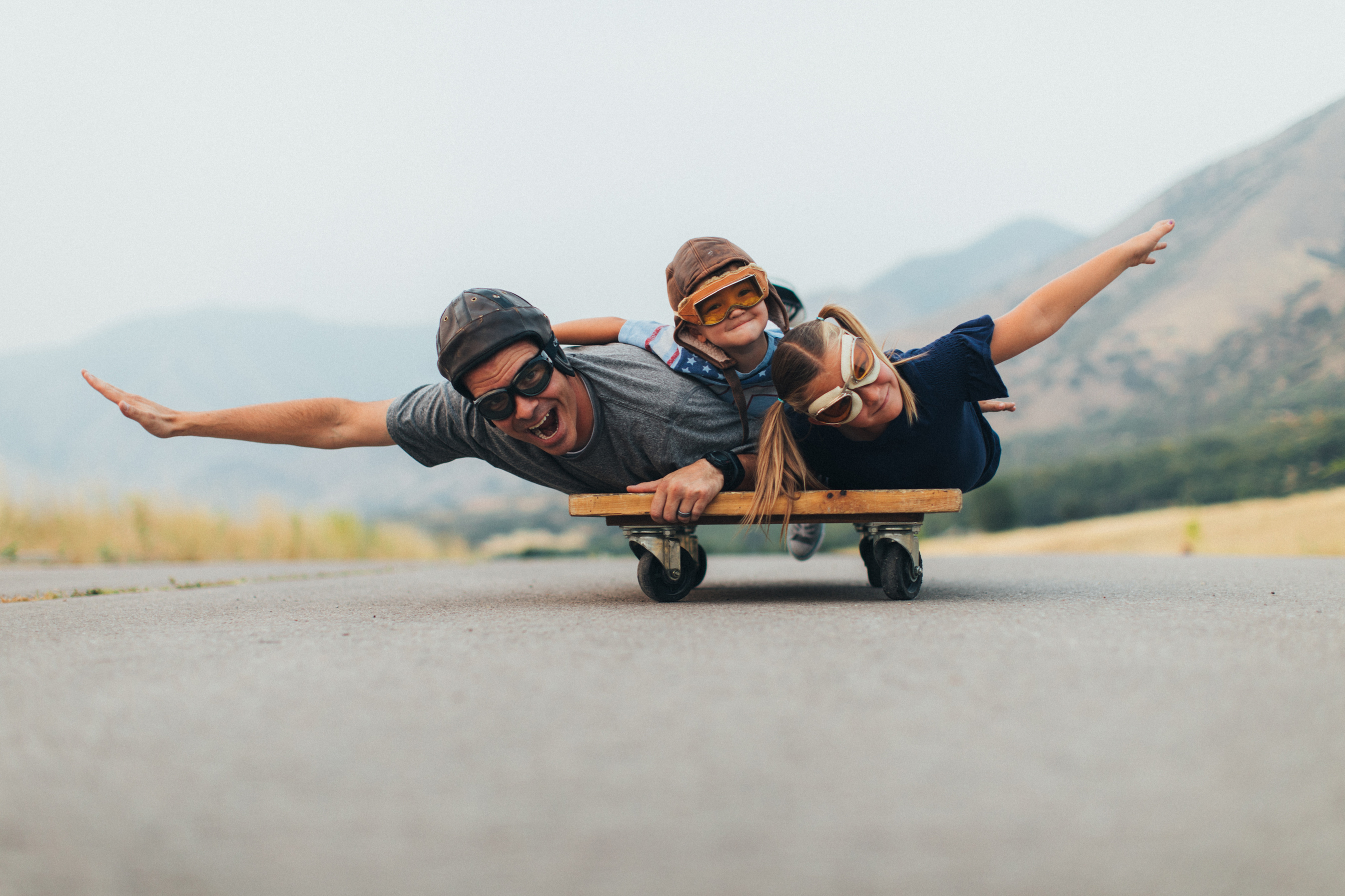 Young Kids and Dad Flying on a Press Cart